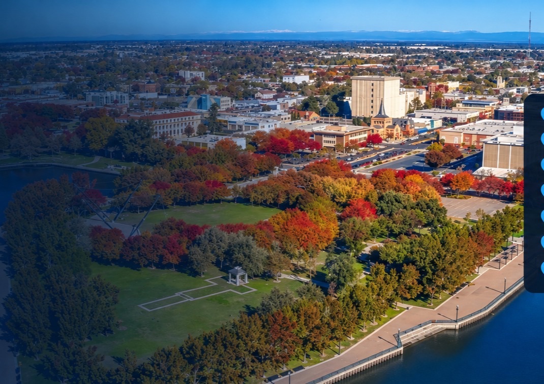 Aerial view of downtown Stockton and its waterfront park in autumn